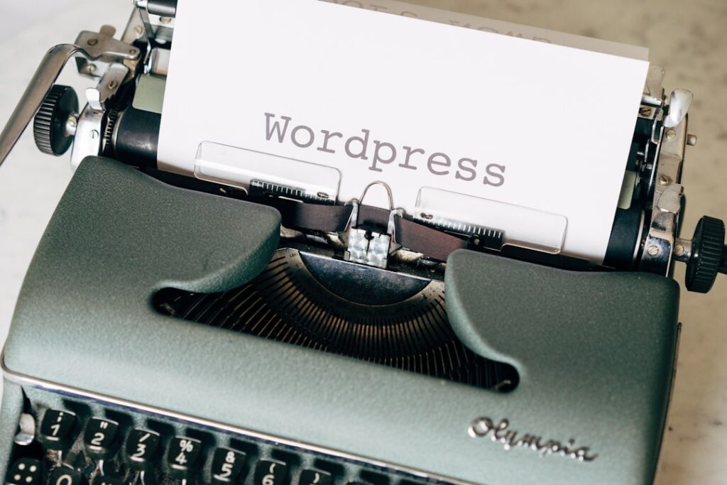 Vintage typewriter with WordPress typed on paper, representing WordPress content creation and tools