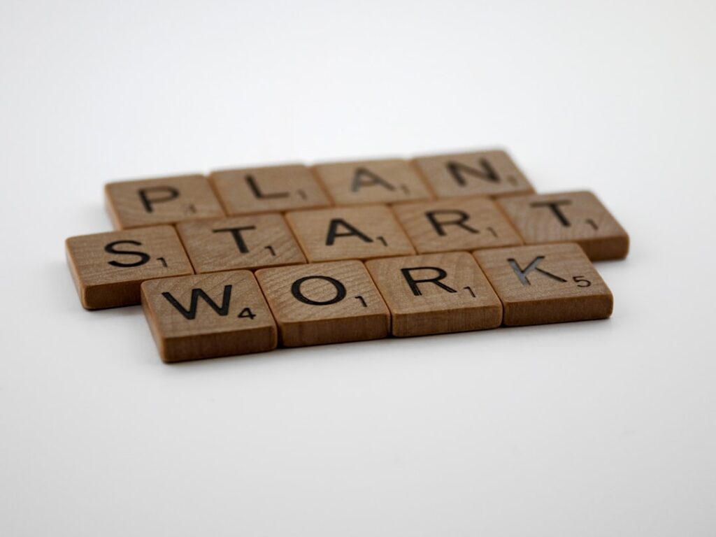 Scrabble tiles spelling "Plan Start Work" illustrating best practices for AI writing workflow