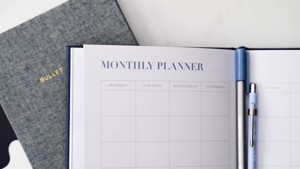 Open monthly planner notebook showing organized calendar layout for content workflow planning