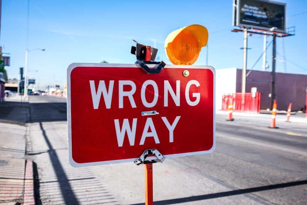 Red wrong way road sign warning about common programmatic SEO mistakes to avoid