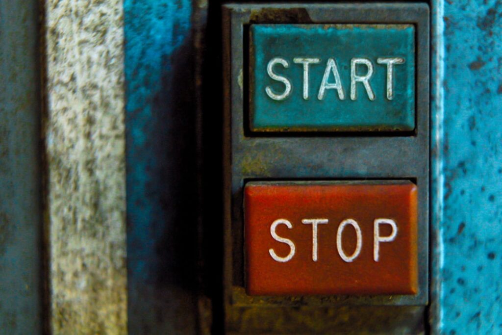 Vintage industrial START and STOP buttons representing the first step in setting up marketing automation