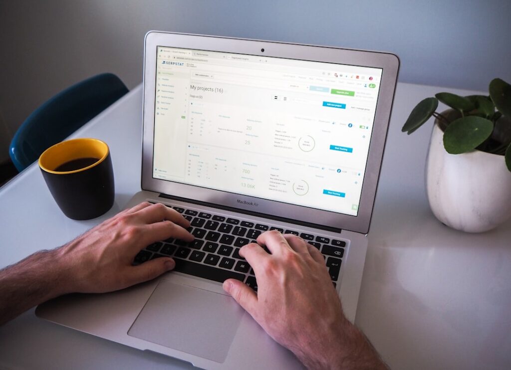 Person using SEO content optimization tool on laptop computer