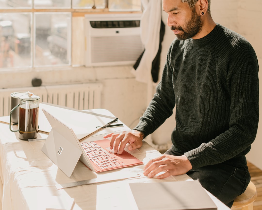 Small business owner working on laptop computer developing SEO strategy. Photo by Wes Hicks on Unsplash