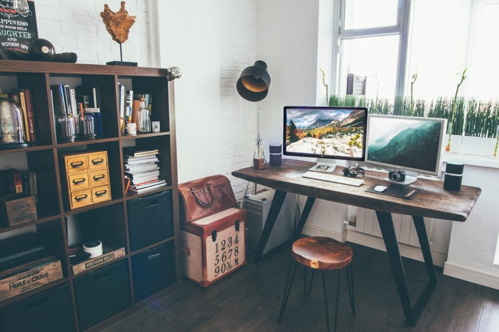 Clean organized home office workspace with computer, desk, and shelving setup ideal for getting started with content creation