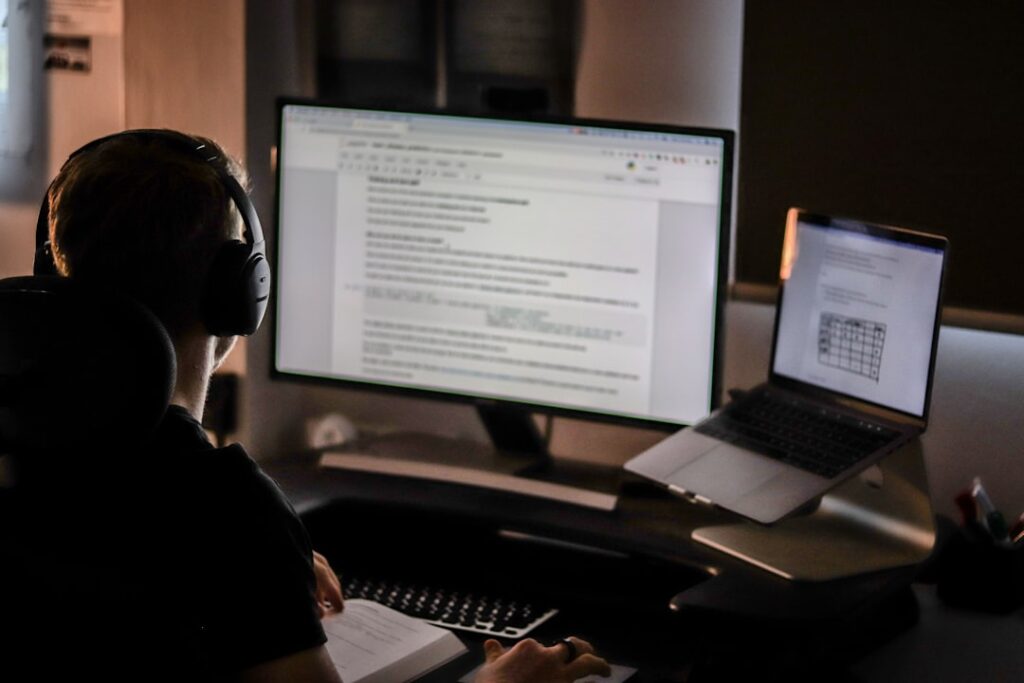 Person reviewing and editing a written document on a large computer monitor, representing the AI article editing and review workflow.