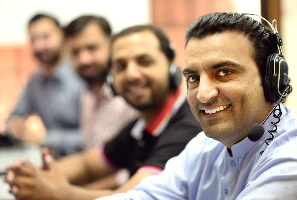 Professional customer support team working at call center providing assistance and onboarding help