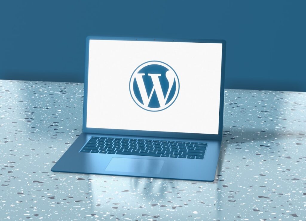 Laptop computer displaying WordPress logo representing CMS integration and plugin development