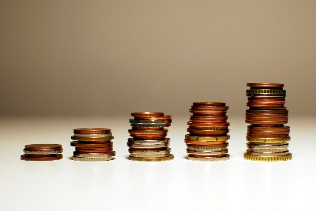 Stacks of coins increasing in height representing different content agency pricing tiers