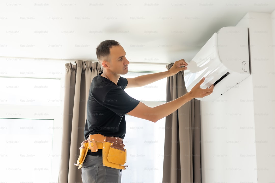 HVAC technician working on air conditioning unit — AI blog writer for HVAC companies