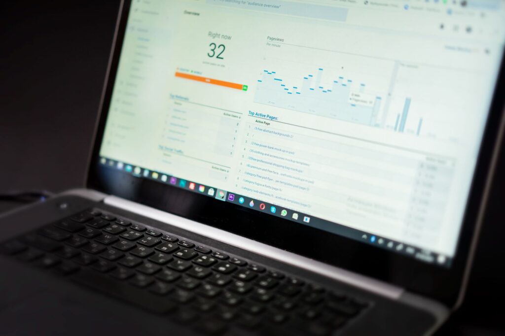 Laptop displaying a web analytics dashboard with traffic data and active pages, representing organic search performance data for AI content