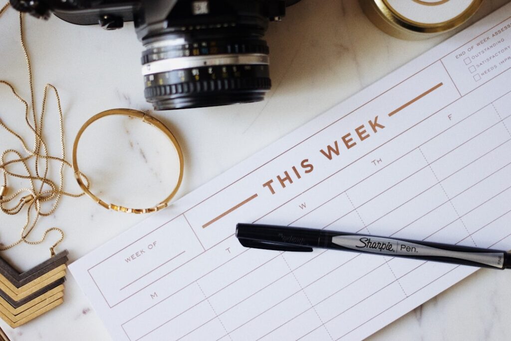 This Week planner pad with pen — representing the structured weekly keyword ranking review process for content decision-making