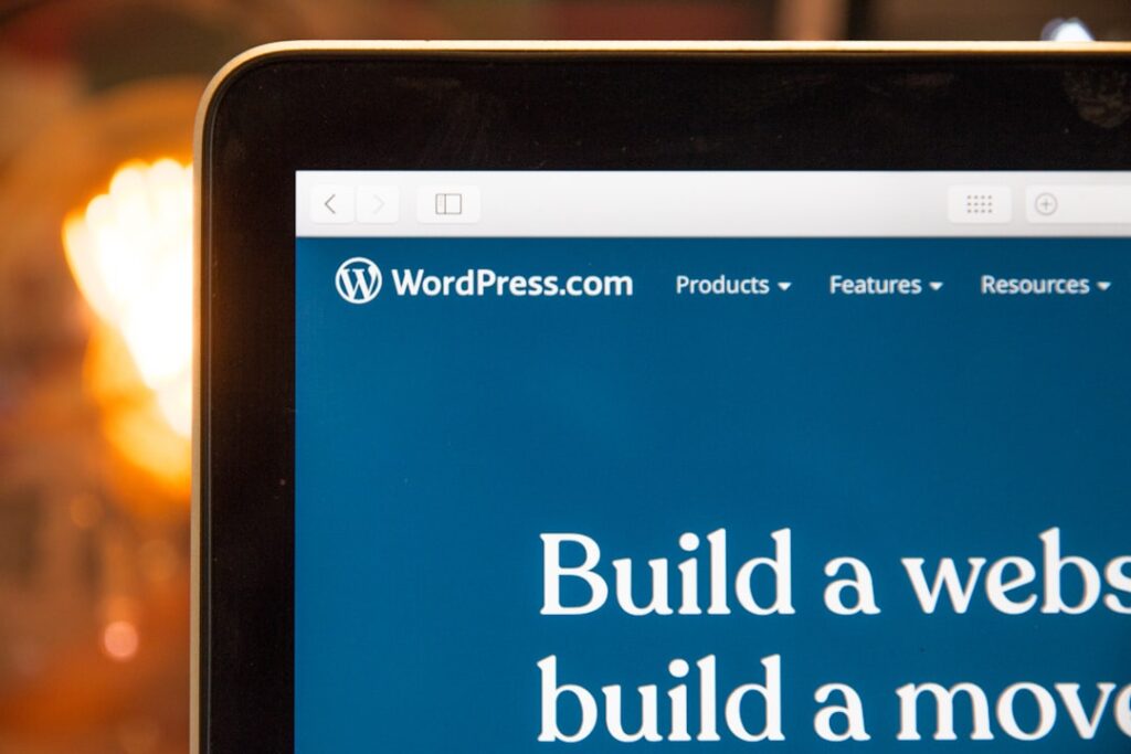 WordPress.com website displayed on a laptop monitor showing the Build a Website homepage