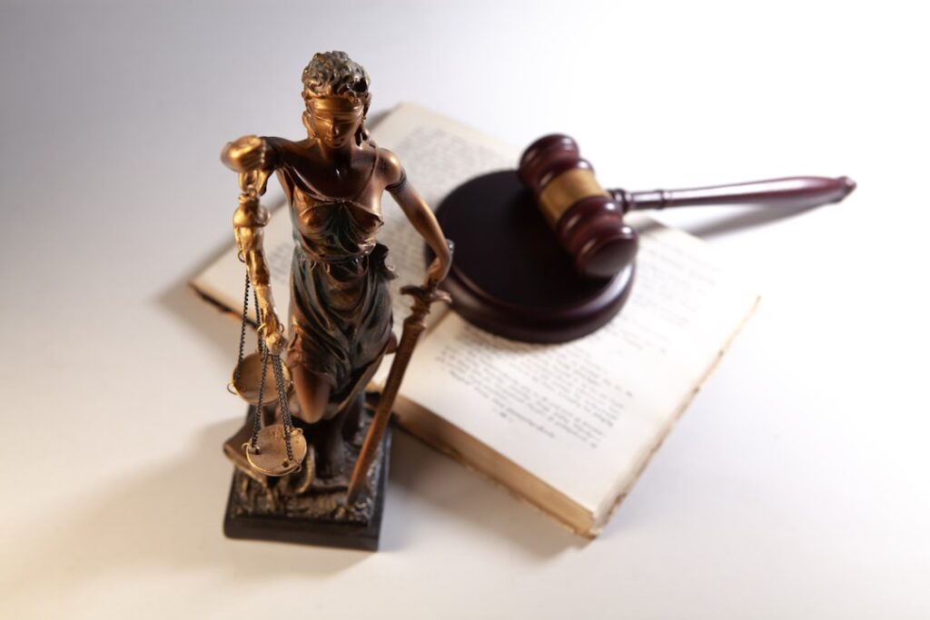 Scales of justice, judge's gavel, and law books representing legal compliance considerations for attorney content