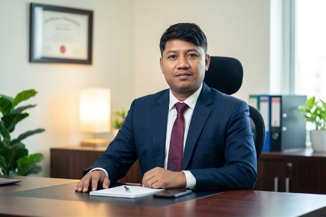 Attorney in professional suit seated at law office desk with diploma on wall — AI blog writer for lawyers