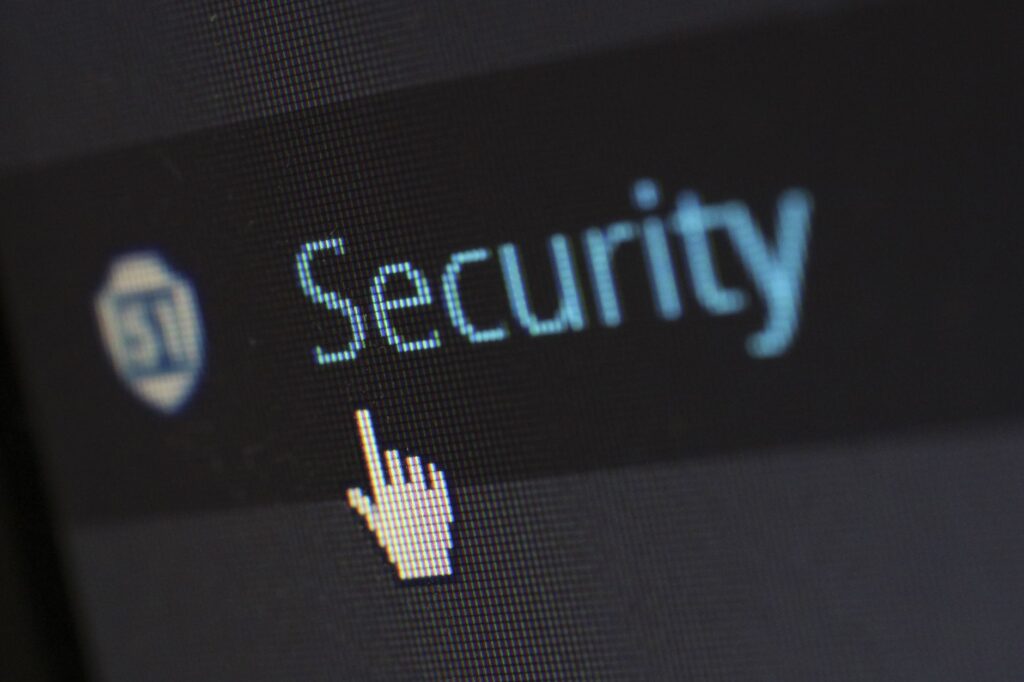 Cursor hovering over Security menu item on a computer screen, representing WordPress security plugin settings that can block REST API write requests