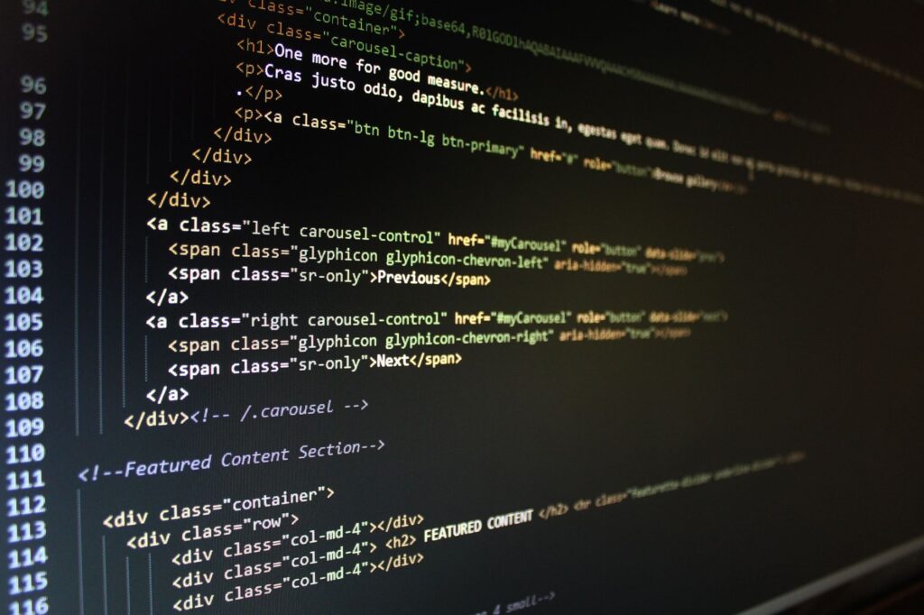 HTML source code on a dark monitor screen showing structured markup, representing JSON-LD schema validation in view-source