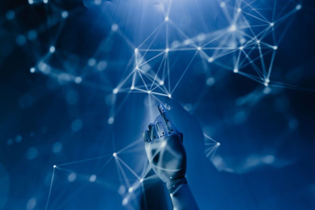 A robotic hand reaching into a glowing digital network on a blue background, symbolizing AI automation handling content creation tasks for small business blogs.