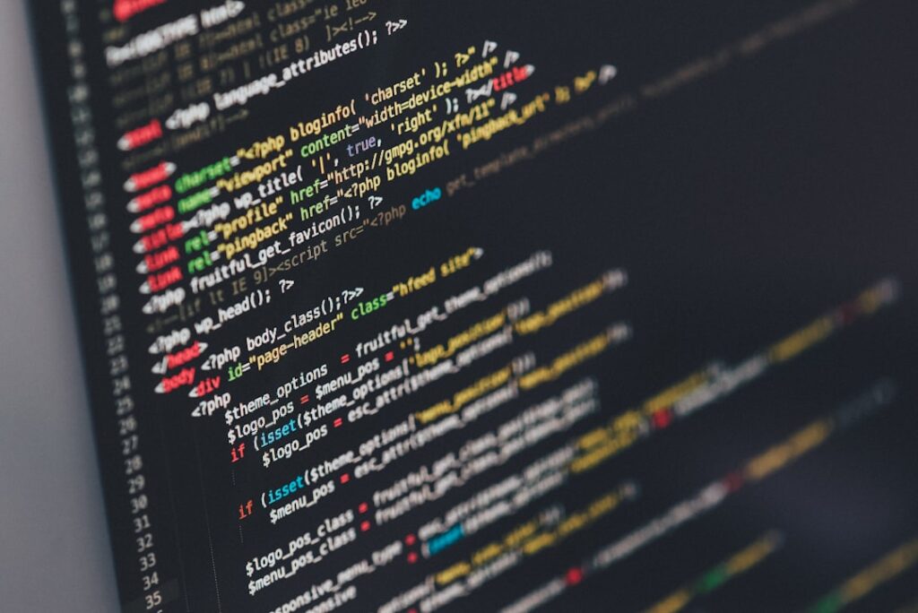 WordPress PHP source code displayed on a dark monitor screen, showing the kind of code that powers the REST API media endpoint.