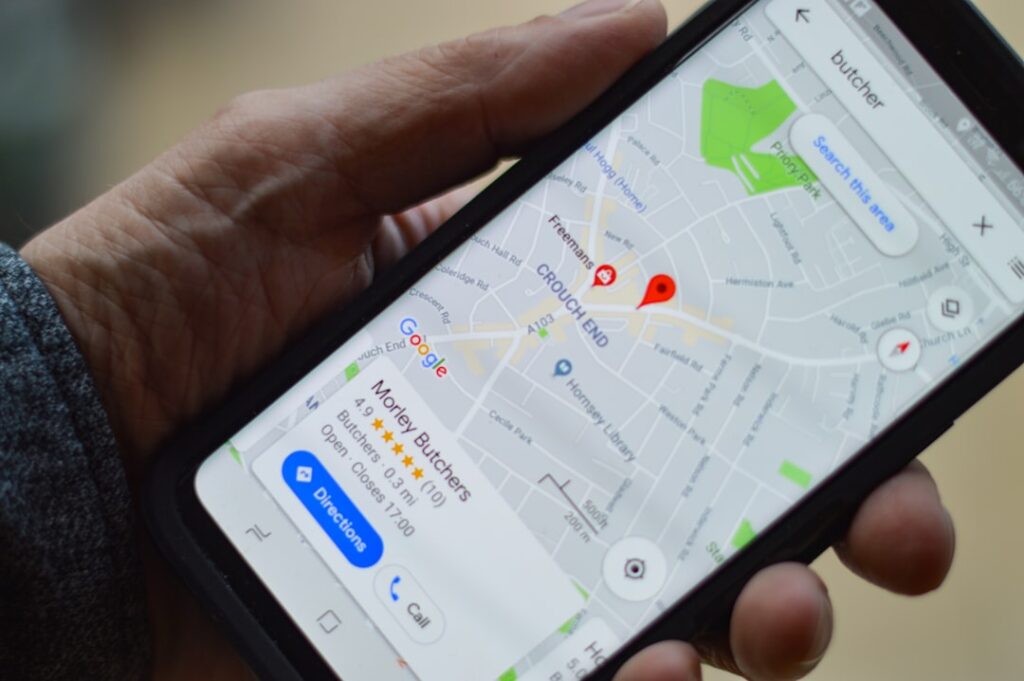 Person holding a smartphone displaying Google Maps with local business pins, representing local SEO search behavior that small businesses need to capture.
