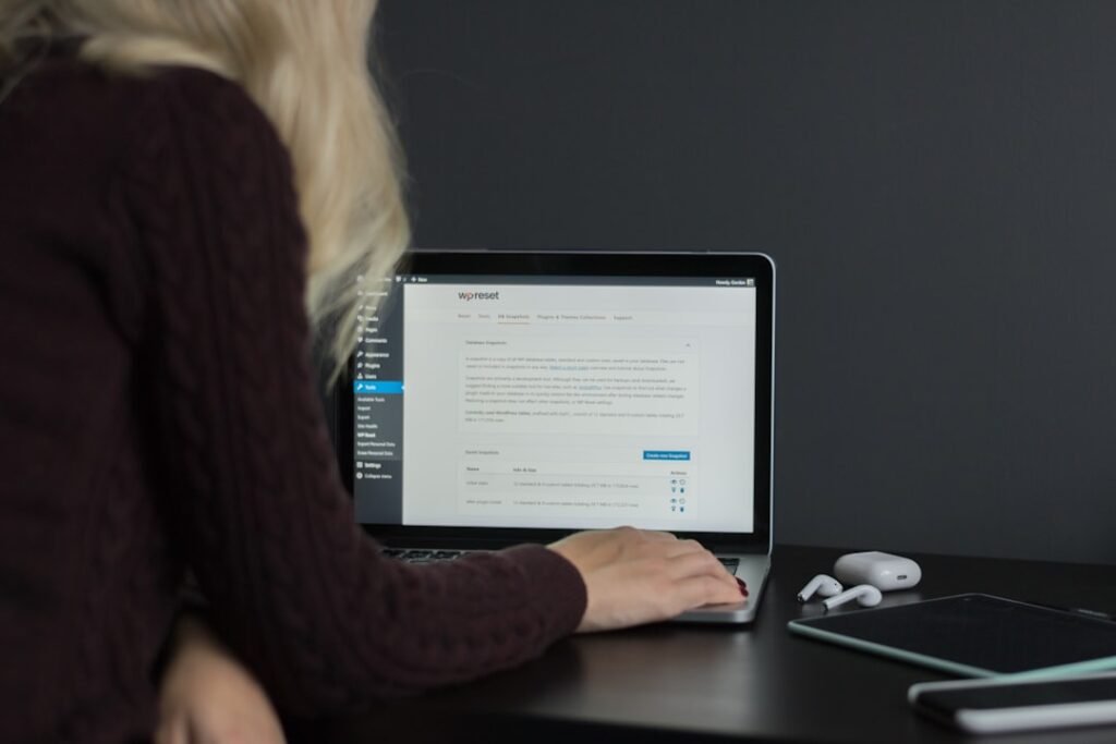 Person editing a WordPress post on a MacBook laptop, illustrating the manual editing time that quality settings add to each article