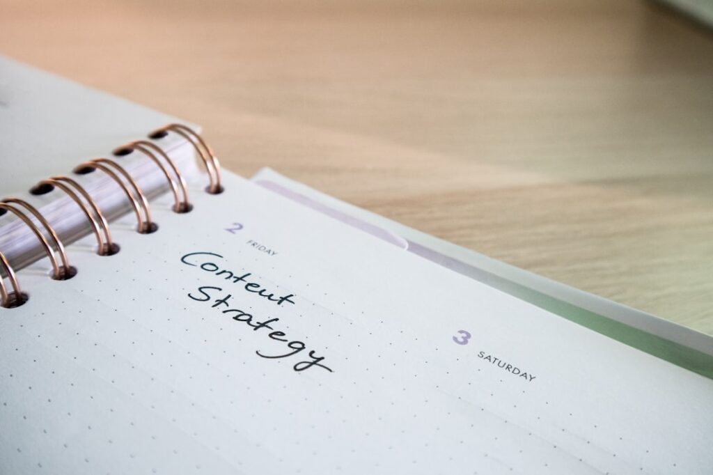Open planner notebook with the words Content Strategy written on a page, representing strategic content planning