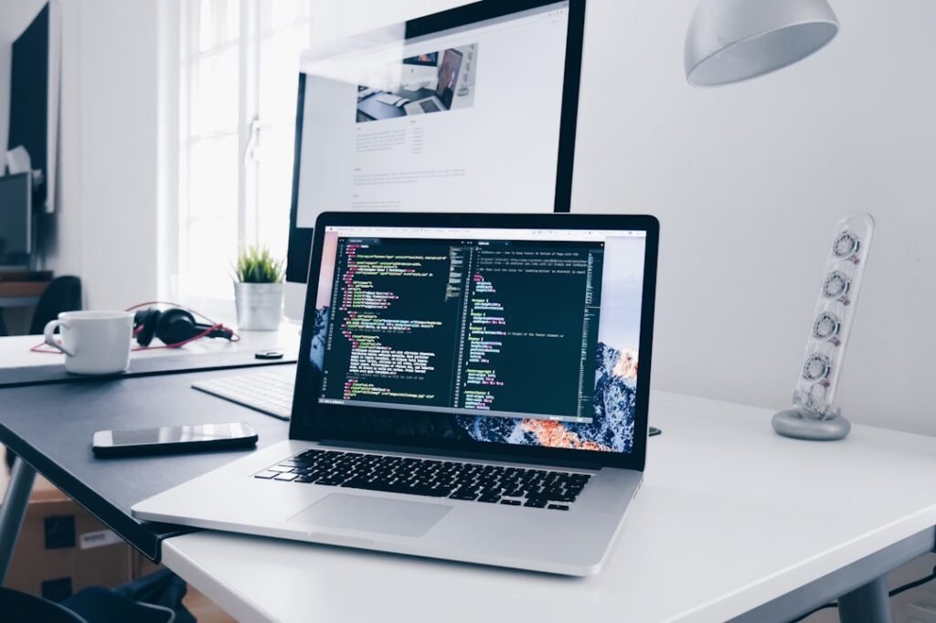 Developer laptop with code editor open on a clean desk, representing hands-on WordPress debugging.