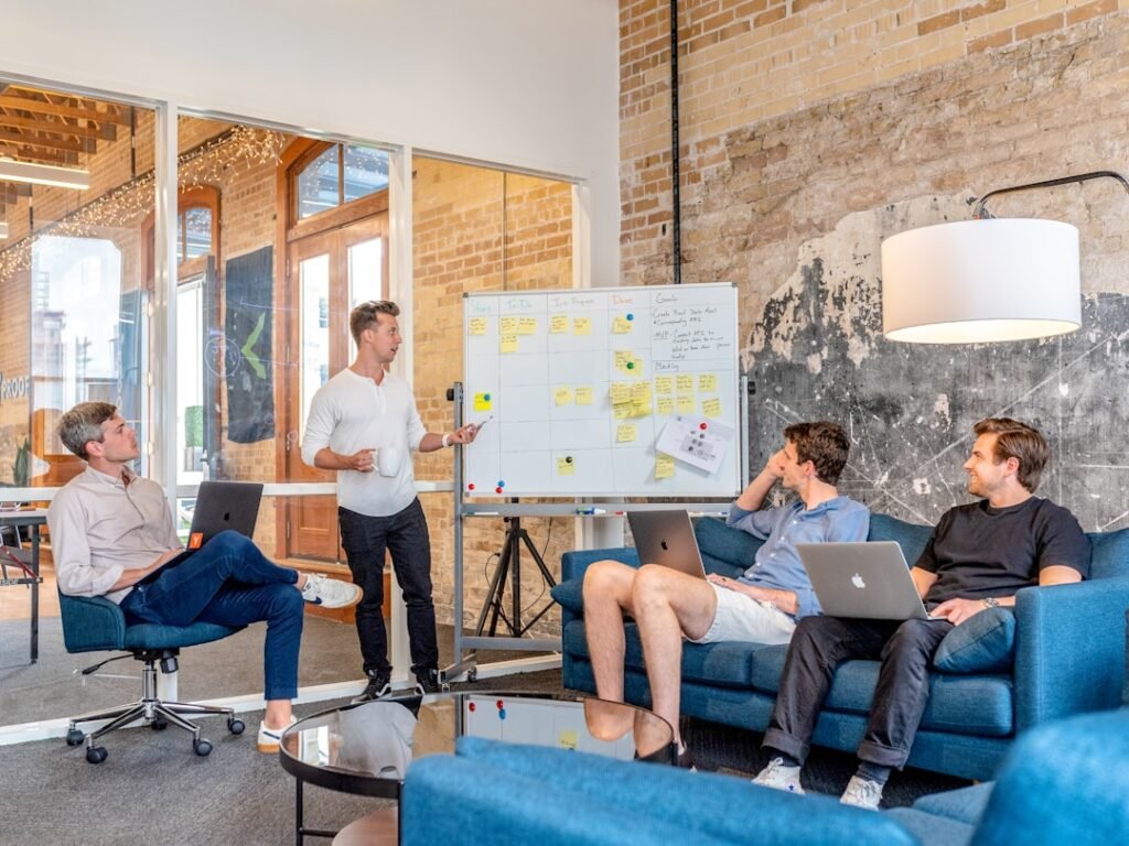 Marketing agency team reviewing content strategy around a whiteboard