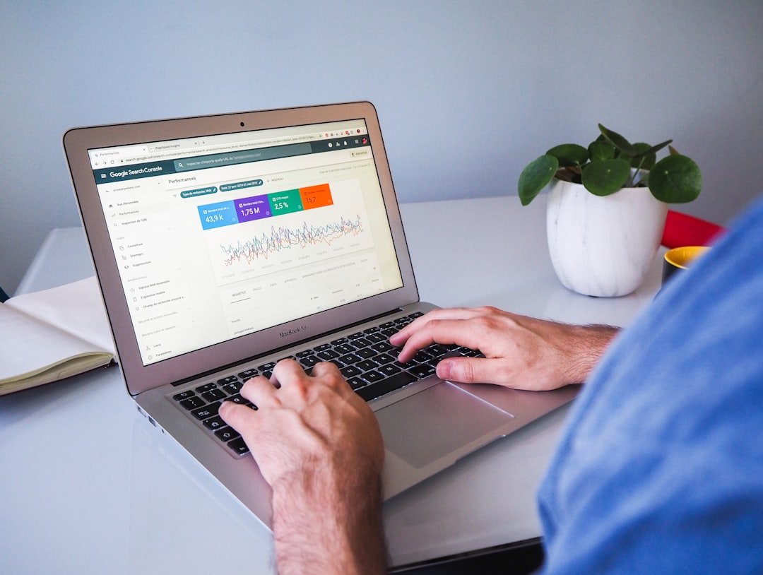 Person using Google Search Console on a laptop — SEO keyword research and ranking data