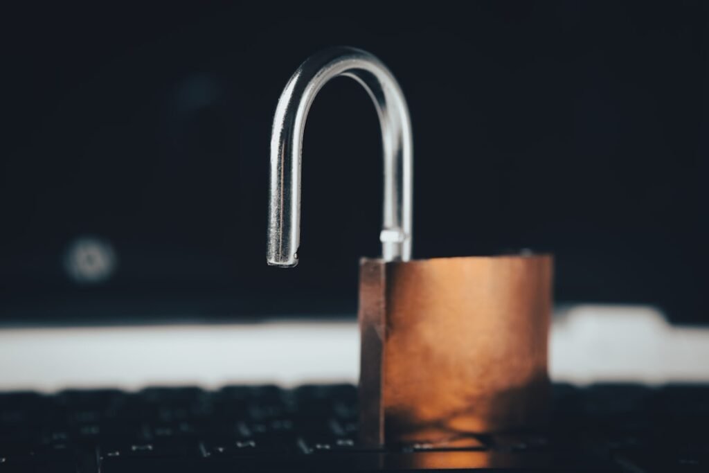 An open padlock resting on a laptop keyboard, representing a broken SSL detection that fails to recognize an encrypted connection