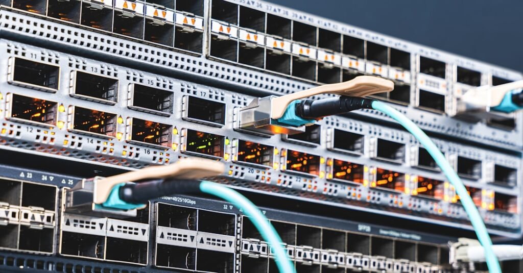High-density fiber optic network switch with aqua cables representing CDN and load balancer infrastructure like Cloudflare and CloudFront