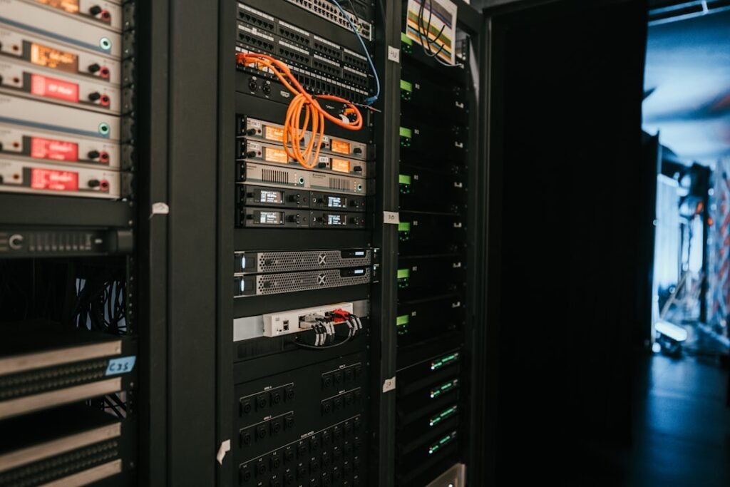 Server rack with orange cables and stacked hardware units in a data center, representing host-level infrastructure where PHP-FPM and Nginx timeout settings are configured.