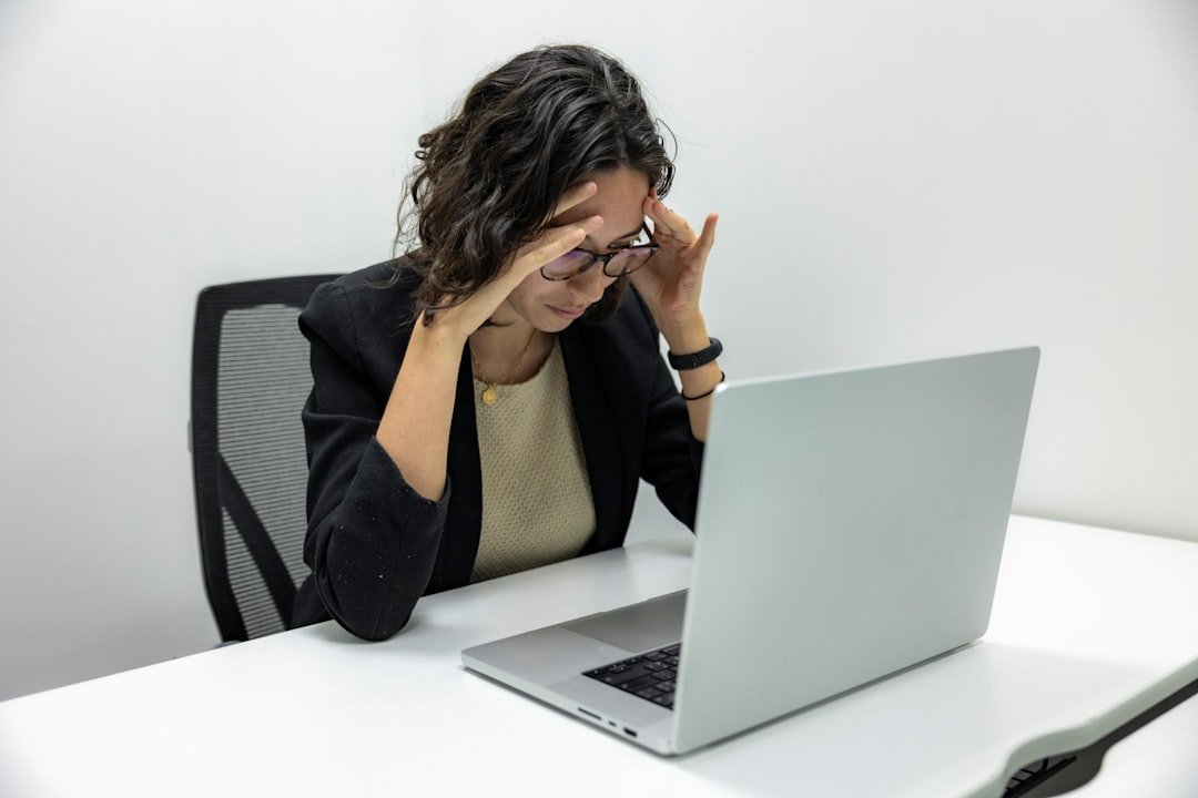 Stressed small business owner looking at laptop, frustrated with SEO results