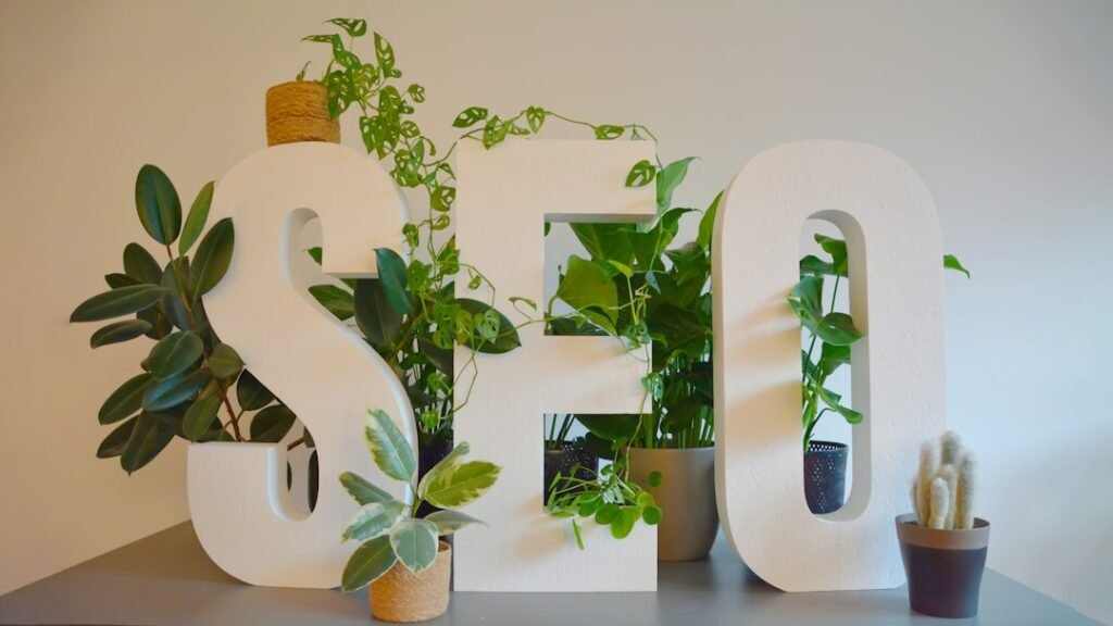 Large SEO letters surrounded by lush green plants representing organic search growth as a long-term content investment strategy.