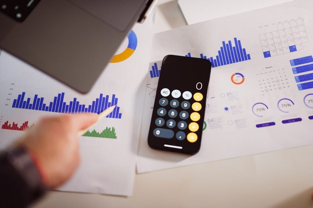 Calculator and business charts showing SEO retainer cost breakdown and per-deliverable math