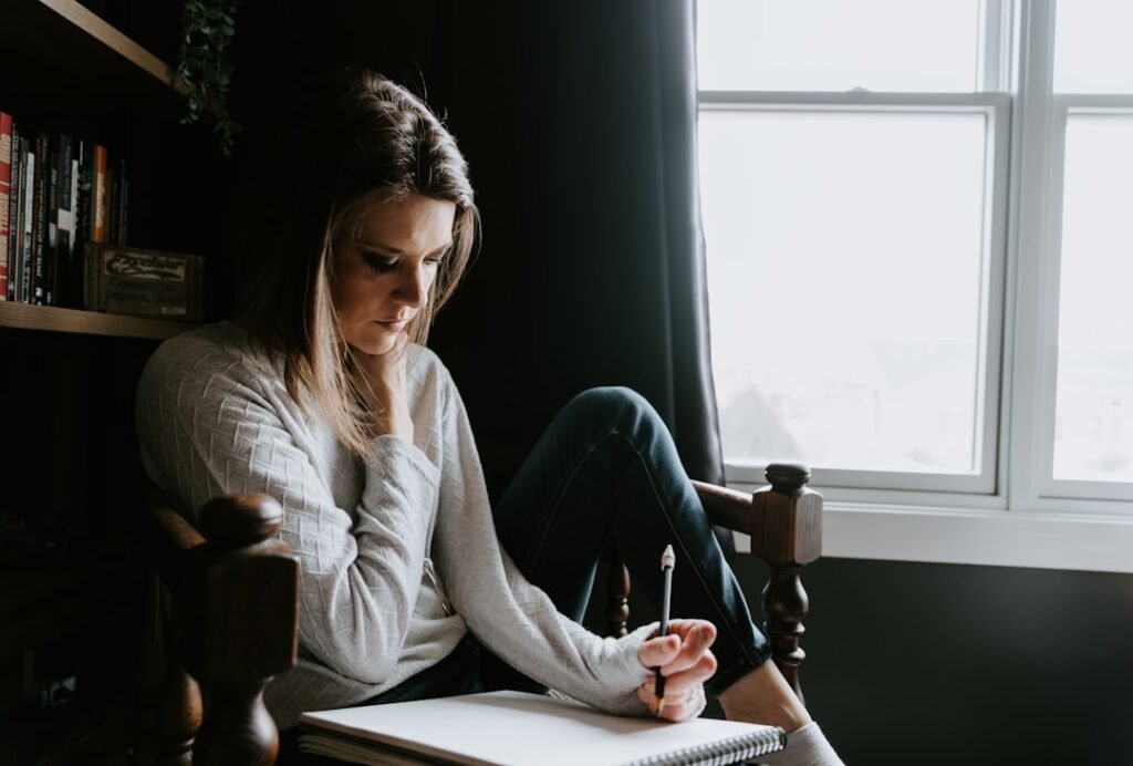 Woman carefully reviewing and editing written content, representing the human review step in an AI content workflow