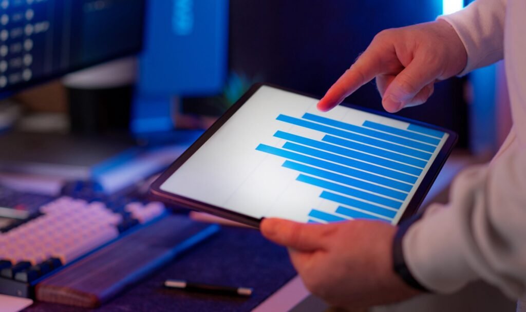 Professional analyzing bar chart data on a tablet, reviewing citation and ranking comparison metrics