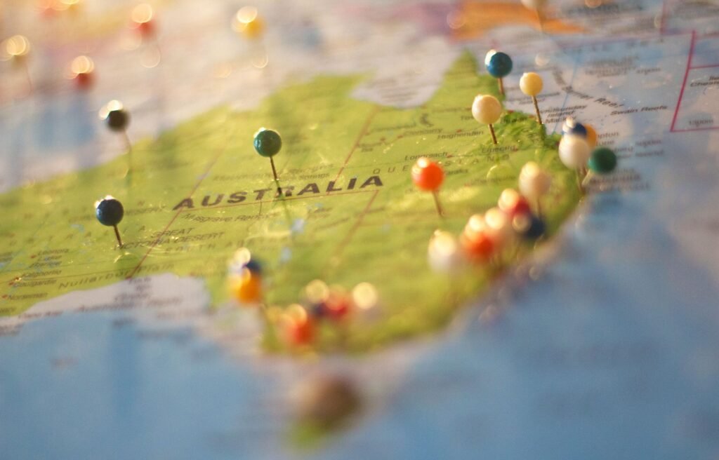 Close-up of a map with colorful pins marking multiple city locations, representing programmatic local SEO targeting across service areas.