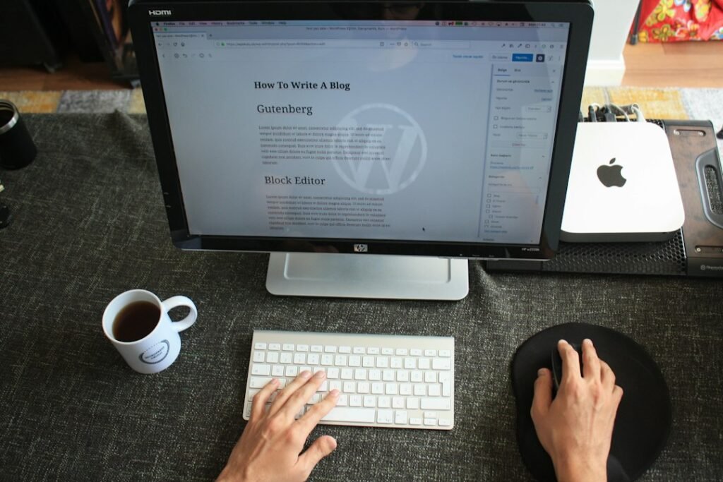 Person working on WordPress Gutenberg block editor on a desktop monitor, writing and publishing blog content as part of a weekly SEO workflow