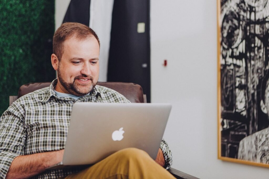 Small business owner relaxed and working independently on a laptop, representing the self-managed SEO content workflow