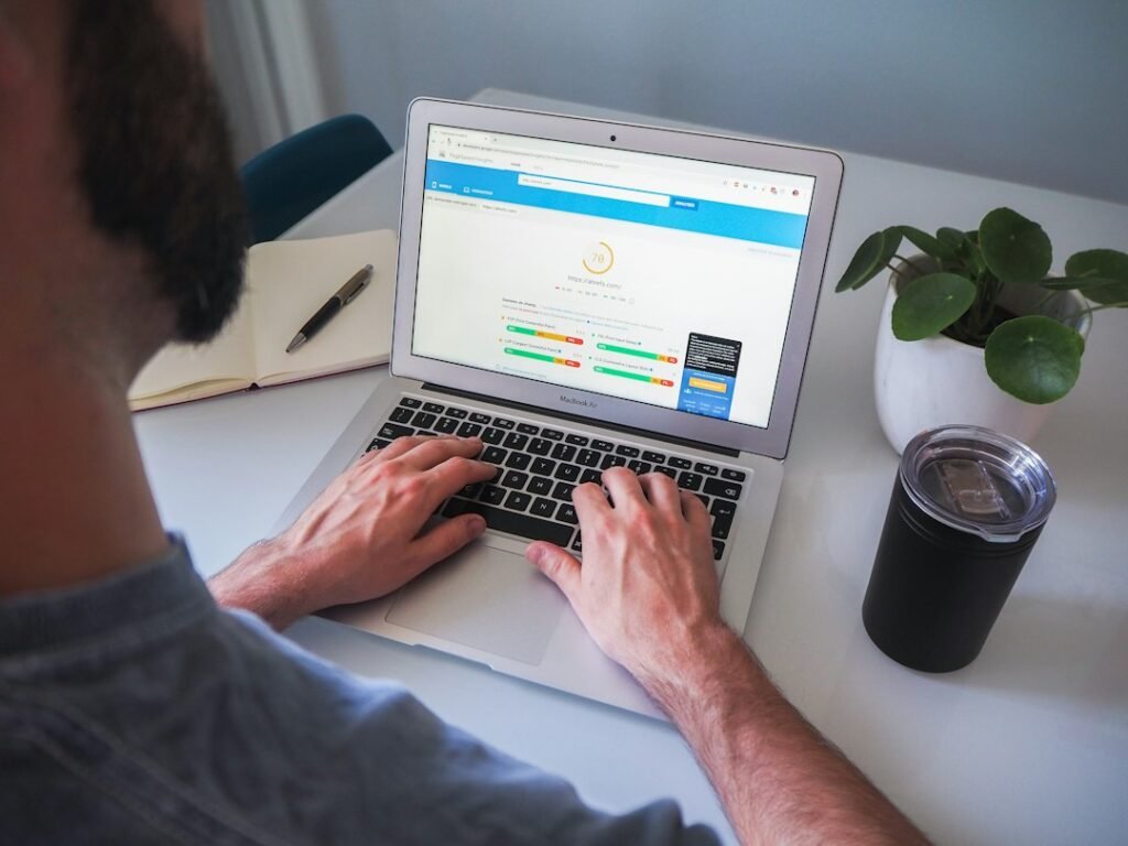 Person running a technical SEO performance audit on a laptop, representing mobile-first indexing analysis