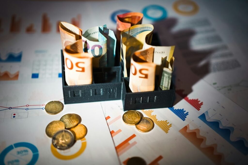 Currency notes and coins resting on financial charts and graphs, representing the cost comparison between Semrush and leaner SEO alternatives