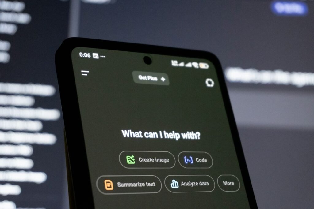 Smartphone screen displaying an AI chatbot interface with prompt options for creating images, writing code, and analyzing data.