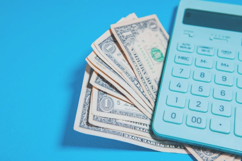 Calculator and dollar bills representing affiliate commission earnings math