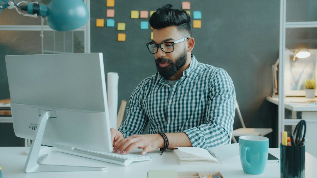 A content professional reviewing and editing work at a computer — representing the human approval layer in AI-assisted content publishing. Photo by Unsplash.